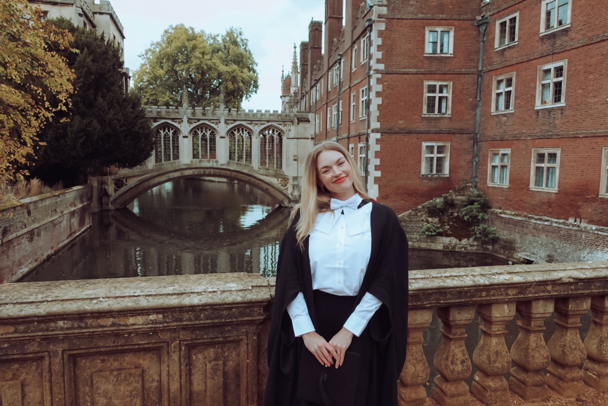 Graduation portrait beside the river at St John's College